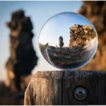 Una esfera de cristal reflejando un paisaje natural.